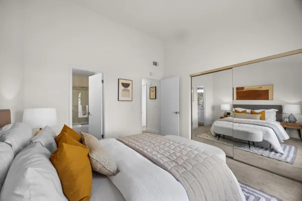 a bedroom with a bed and lamp