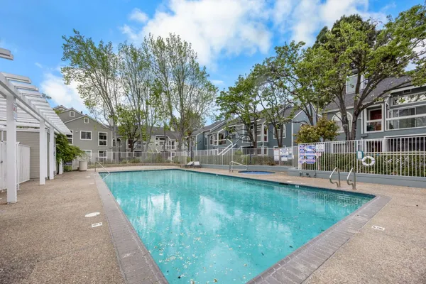 a view of a swimming pool with outdoor seating