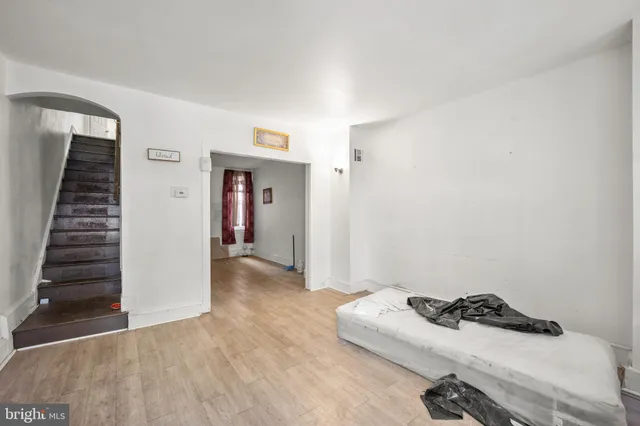 a room that has a bed and a wooden floor