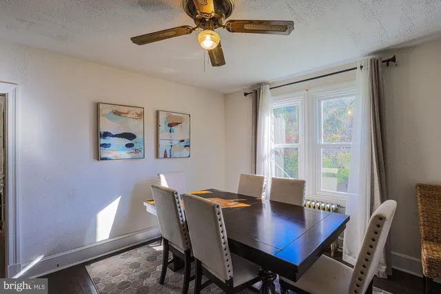 a living room with furniture a wooden floor and a chandelier