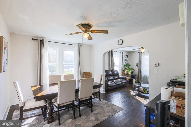 a living room with table chairs and a dining table