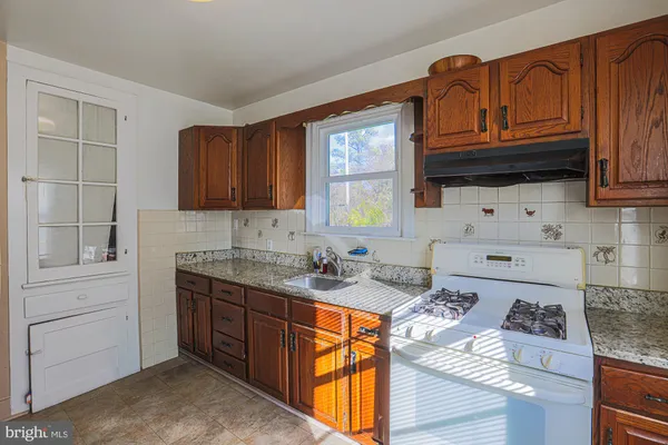 a kitchen with a refrigerator sink and stove