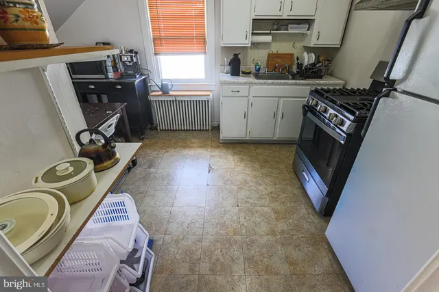 a kitchen with a appliances and cabinets
