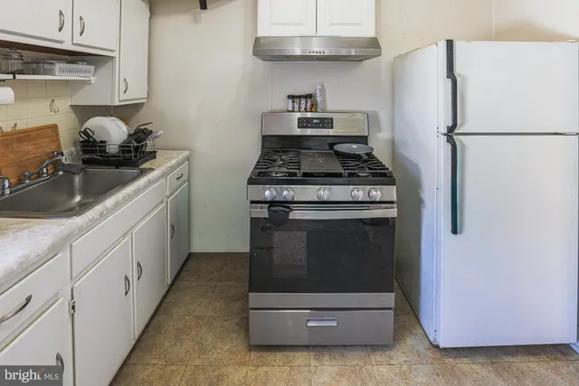 a view of a room with wooden floor and window