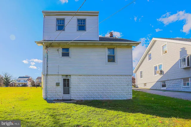 a view of a white house with a yard
