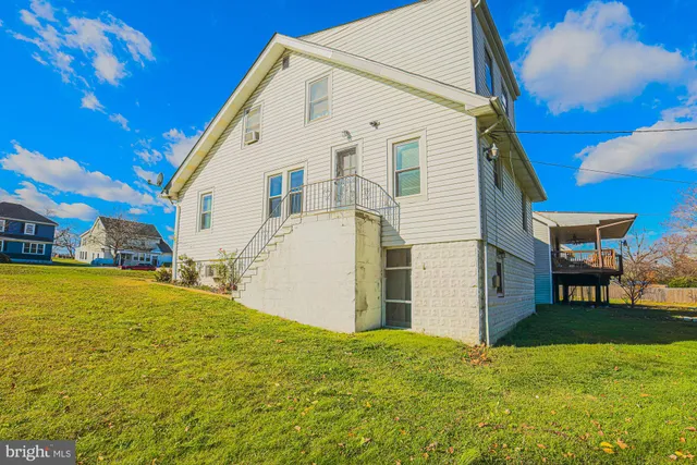 a view of a white house with a yard