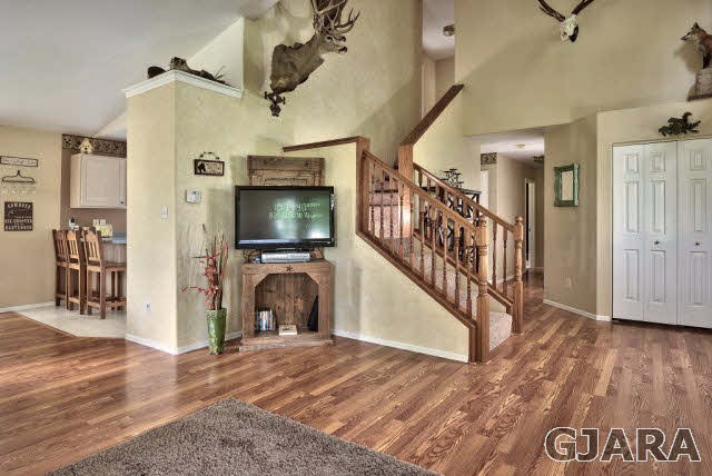 1337 21 Road Grand Junction, CO 81505 - Photo 8 of 9 a view of a livingroom with wooden floor and a ceiling fan
