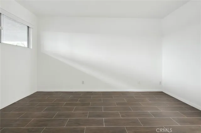 a view of an empty room and wooden floor