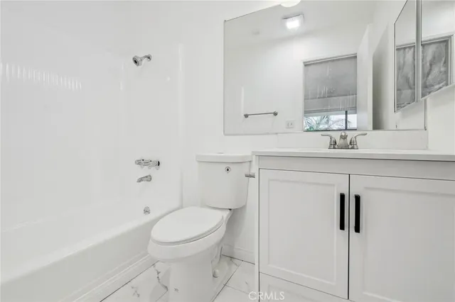 a bathroom with a toilet and a bathtub