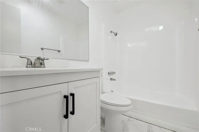 a bathroom with a sink a mirror and shower