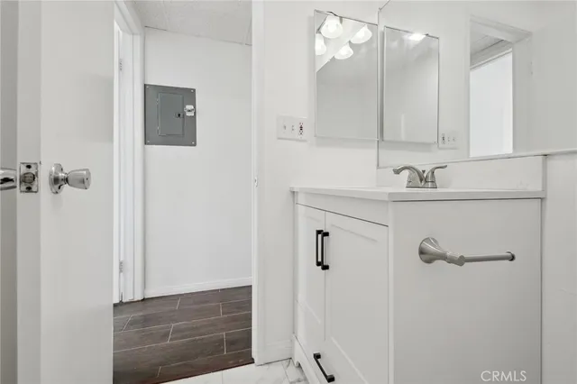 an empty room with wooden floor and a window