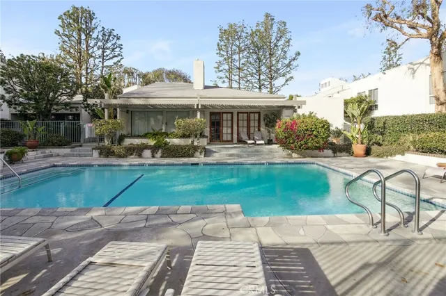 a swimming pool with outdoor seating