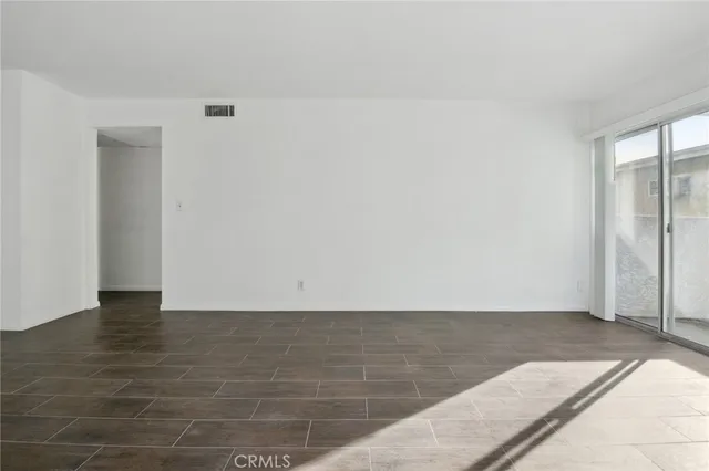 an empty room with wooden floor