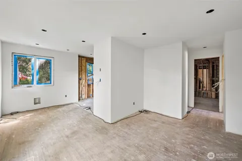 a view of a room with wooden floor and windows