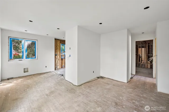 a view of a room with wooden floor and windows
