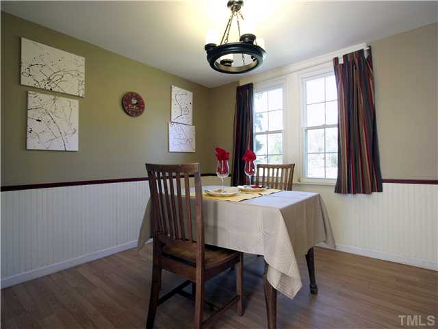 12700 School House Road Middlesex, NC 27557 - Photo 11 of 25 Dining room has beadboard wainscot and a double window overlooking the verdant back yard.