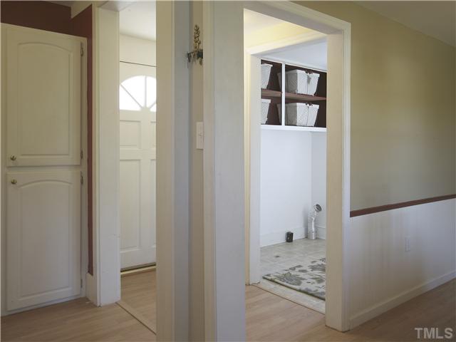 12700 School House Road Middlesex, NC 27557 - Photo 13 of 25 Laundry room is adjacent to the back door, just off the kitchen. Has electric dryer hook-up and vent. Convenient shelving above the appliances.