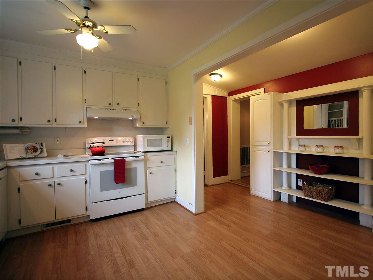 12700 School House Road Middlesex, NC 27557 - Photo 14 of 25 View from kitchen looking toward the central hallway. Wood-look laminate floors are attractive, durable, and easy to clean.