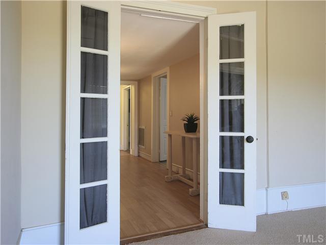 12700 School House Road Middlesex, NC 27557 - Photo 16 of 25 These French doors between the living room and the central hallway are just one of the many wonderful architectural features of the home.