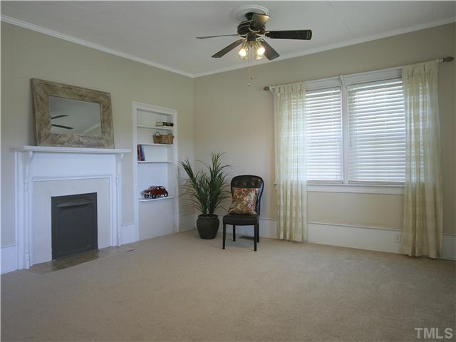 12700 School House Road Middlesex, NC 27557 - Photo 17 of 25 Spacious living room. Built-in book shelves. Decorative fireplace (non-working). Two ceiling fans with lights. New carpet. Current owners added vinyl replacement windows to the home. Heat pump is only five years old.