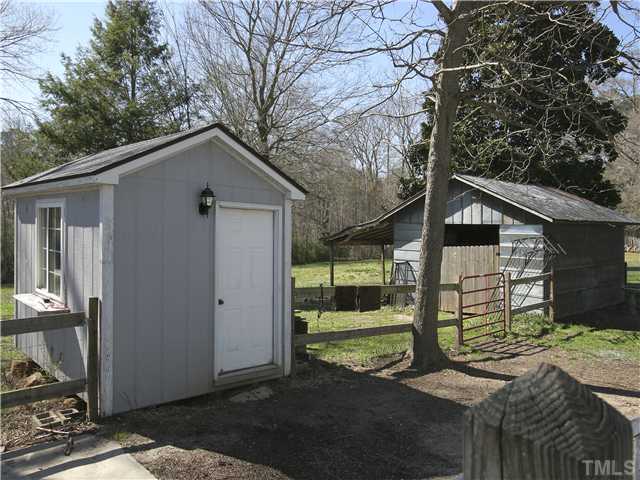 12700 School House Road Middlesex, NC 27557 - Photo 4 of 25 Includes three outbuildings. The wired workshop/potting shed and the small barn/garage are shown here. Great for tool storage, lawnmowers and other gardening equipment.