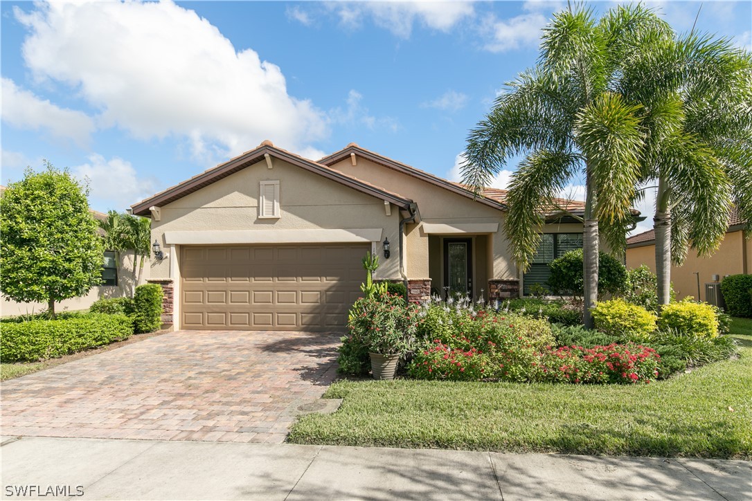 10922 Dennington Road Fort Myers, FL 33913 - Photo 1 of 35 a front view of a house with a yard and garage