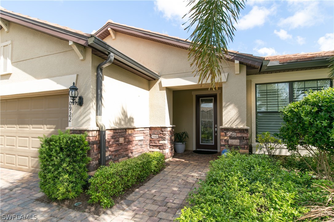 10922 Dennington Road Fort Myers, FL 33913 - Photo 2 of 35 a front view of a house with a yard