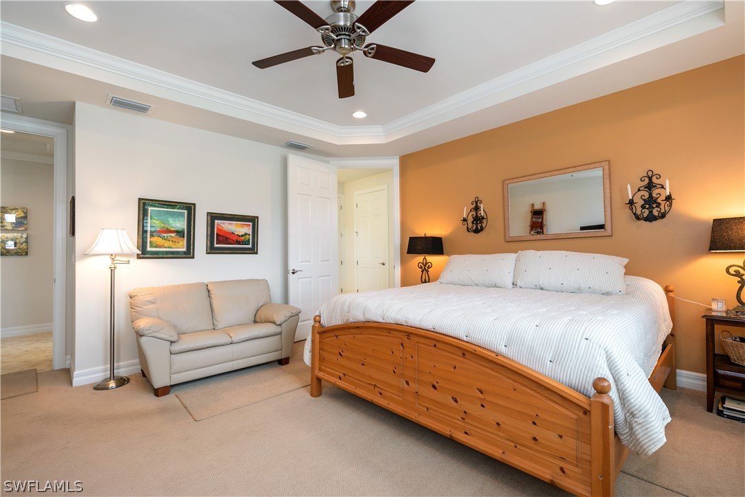 10922 Dennington Road Fort Myers, FL 33913 - Photo 21 of 35 a spacious bedroom with a bed and a chandelier