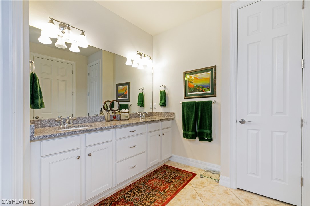 10922 Dennington Road Fort Myers, FL 33913 - Photo 22 of 35 a bathroom with a double vanity sink and a mirror