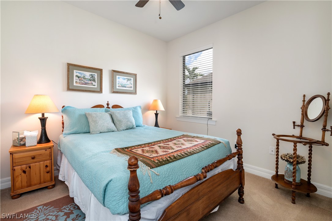 10922 Dennington Road Fort Myers, FL 33913 - Photo 24 of 35 a bedroom with a bed and a chandelier
