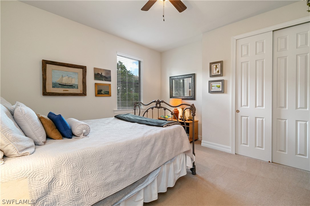 10922 Dennington Road Fort Myers, FL 33913 - Photo 25 of 35 a bedroom with a bed and a chandelier
