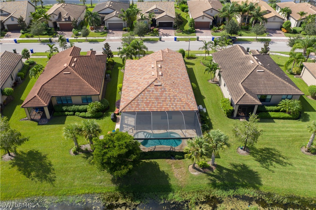 10922 Dennington Road Fort Myers, FL 33913 - Photo 31 of 35 an aerial view of multiple houses with yard