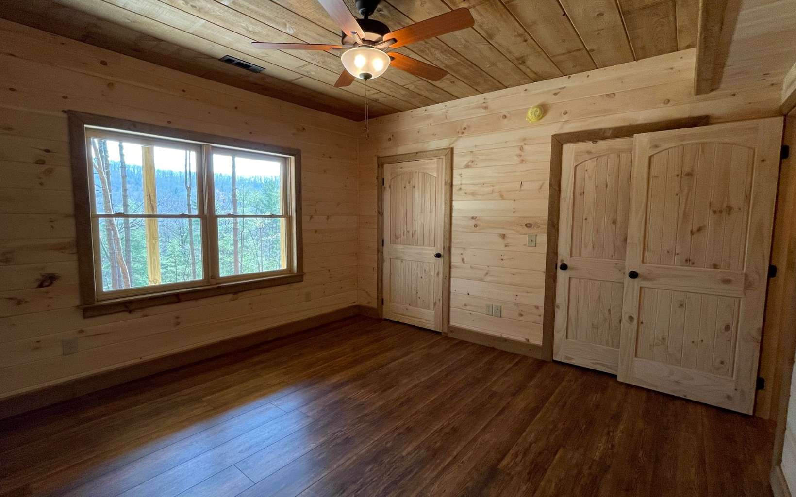 58 Papa Bear Path Cherry Log, GA 30522 - Photo 30 of 33 a view of an empty room with wooden floor and a window