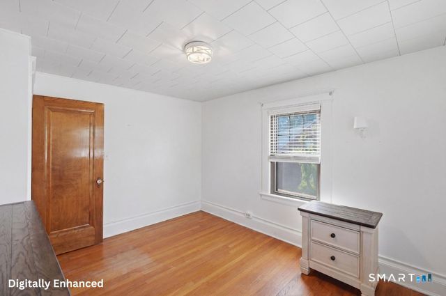 443 Highland Avenue Waterbury, CT 06708 - Photo 17 of 24 a view of an empty room with wooden floor and a window