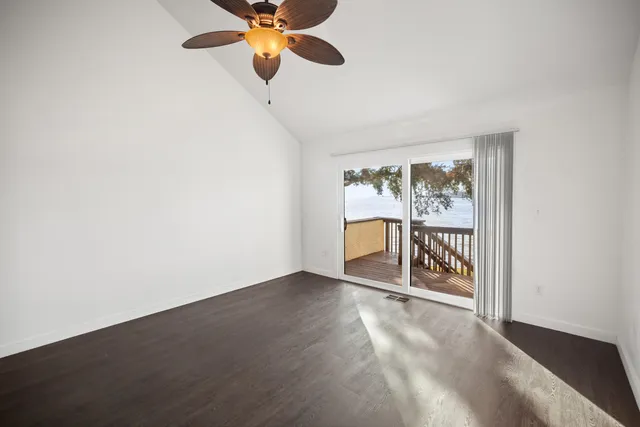 a kitchen with stainless steel appliances granite countertop a refrigerator a stove top oven a sink dishwasher and white cabinets with wooden floor