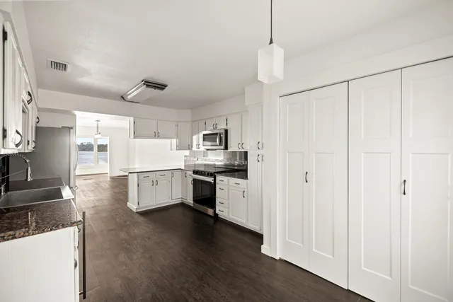 a bathroom with a shower sink and mirror