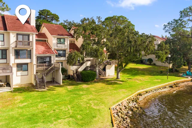 a view of a chairs and table on the wooden deck