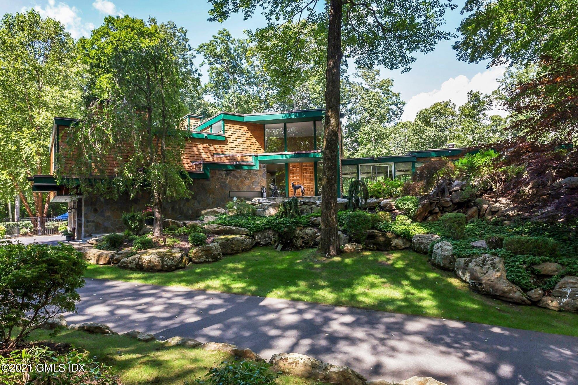 7 Chateau Ridge Road Greenwich, CT 06831 - Photo 1 of 36 a view of backyard with plants and outdoor seating