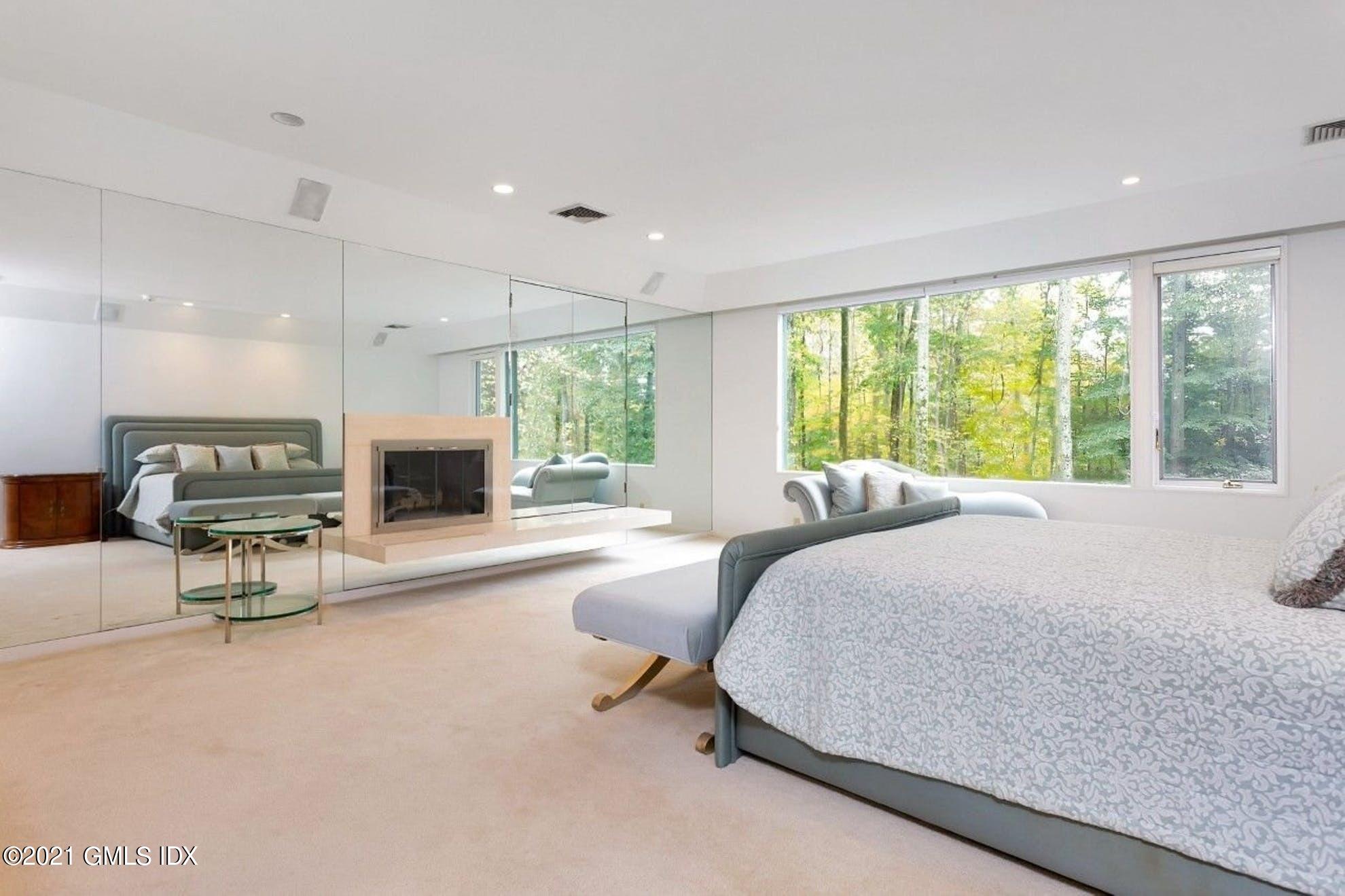 7 Chateau Ridge Road Greenwich, CT 06831 - Photo 11 of 36 a spacious bedroom with a large bed and a large window