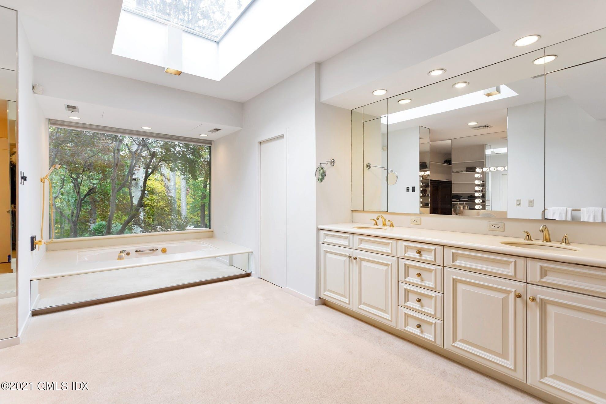 7 Chateau Ridge Road Greenwich, CT 06831 - Photo 12 of 36 a large bathroom with a large tub and sink