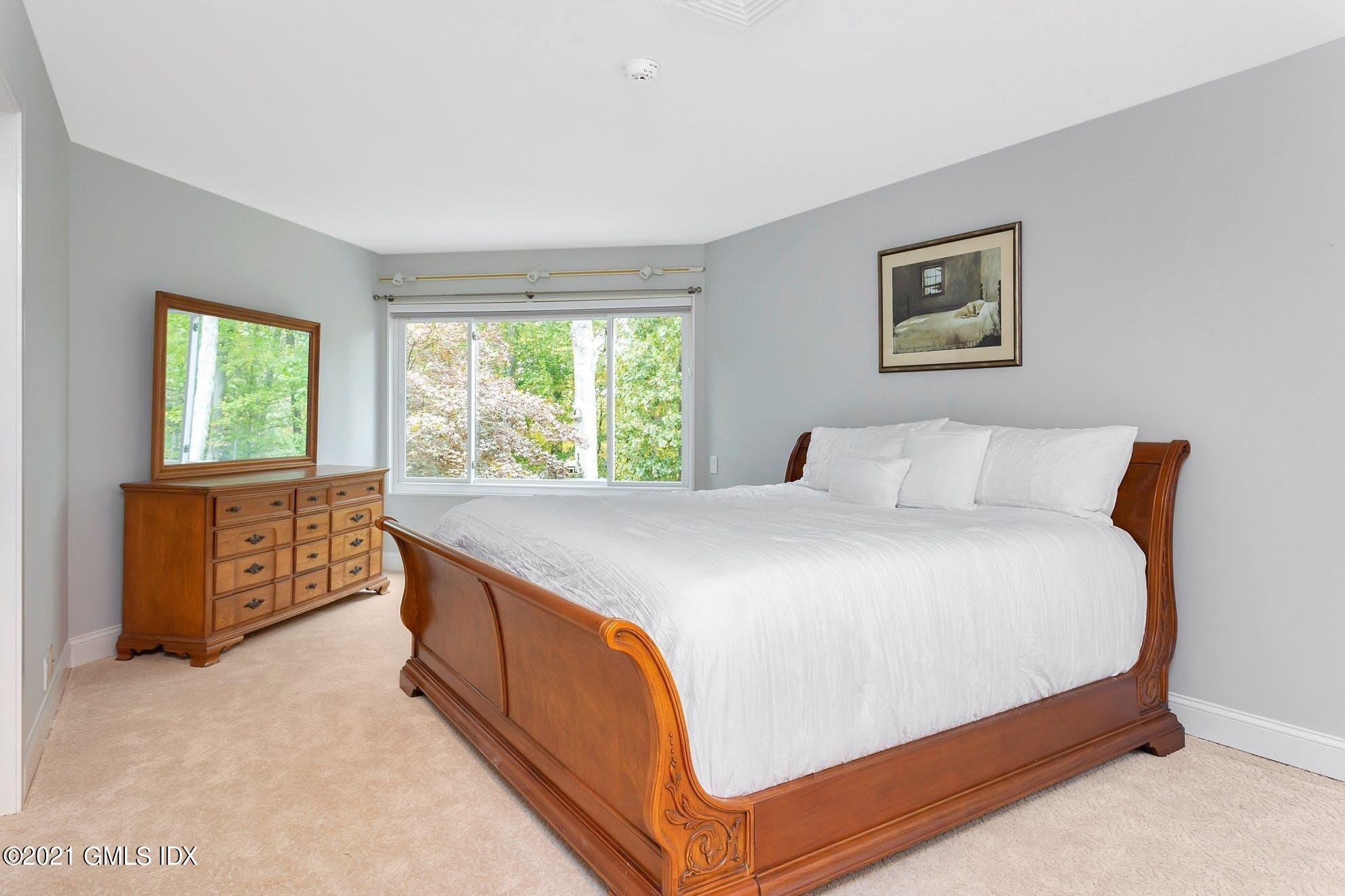 7 Chateau Ridge Road Greenwich, CT 06831 - Photo 14 of 36 a bed sitting in a bedroom next to a window