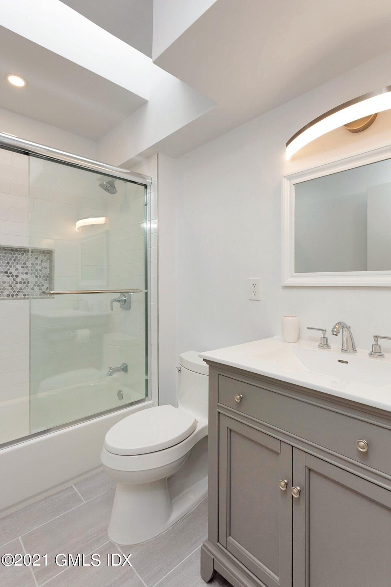 7 Chateau Ridge Road Greenwich, CT 06831 - Photo 17 of 36 a bathroom with a sink a toilet and shower