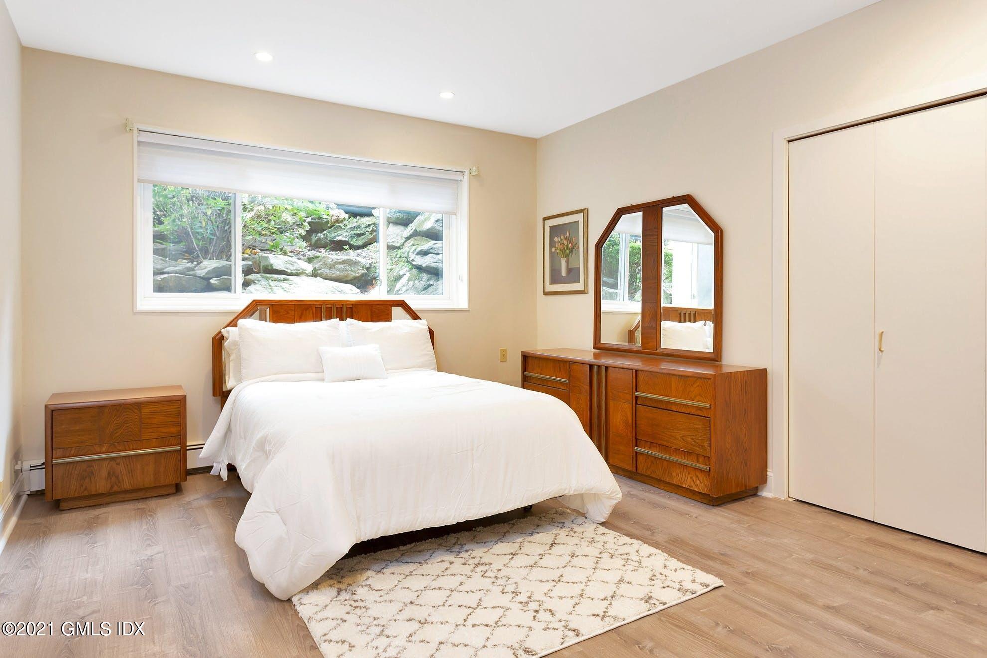 7 Chateau Ridge Road Greenwich, CT 06831 - Photo 22 of 36 a bedroom with a bed and a window