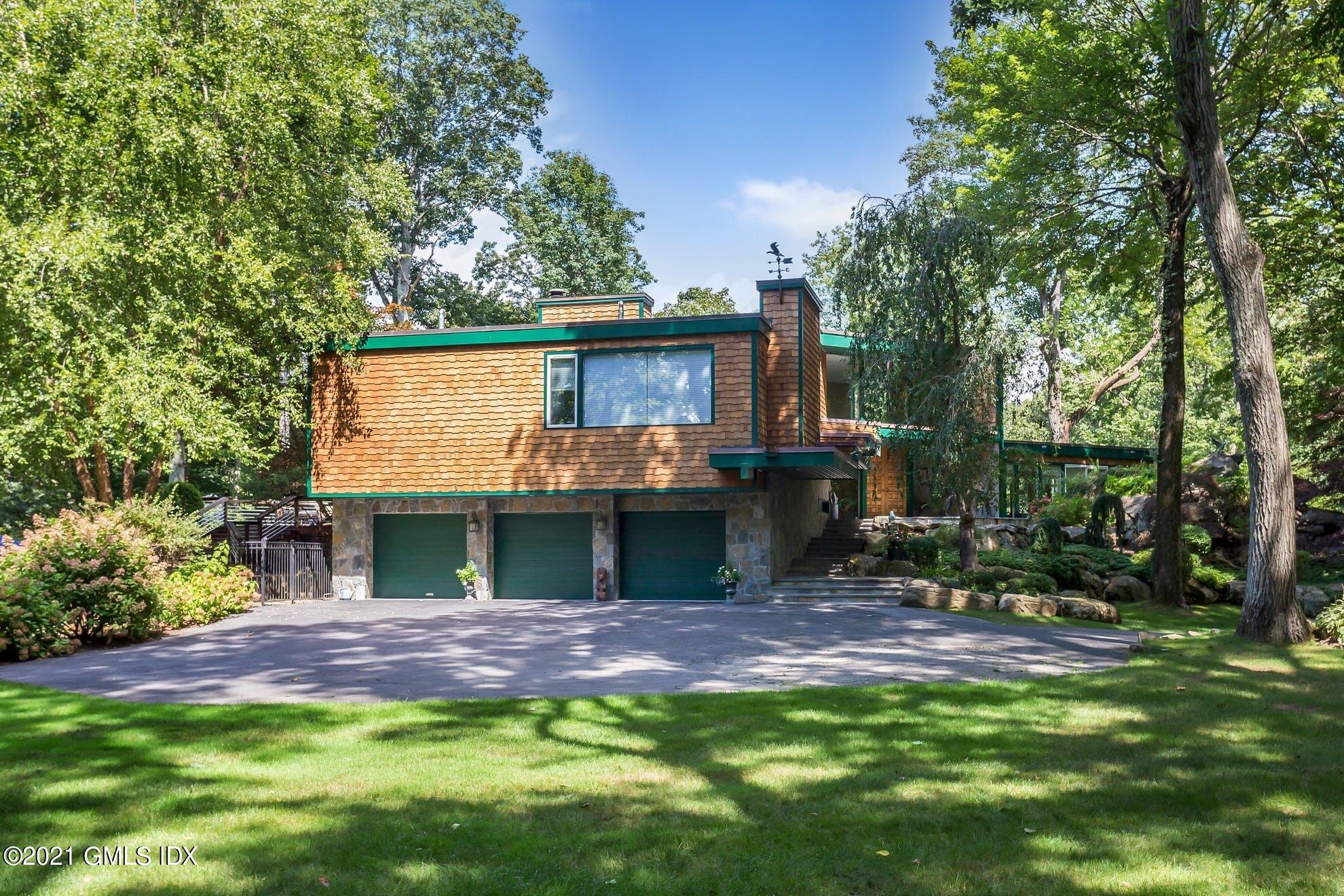 7 Chateau Ridge Road Greenwich, CT 06831 - Photo 32 of 36 a view of a house with a yard and sitting area
