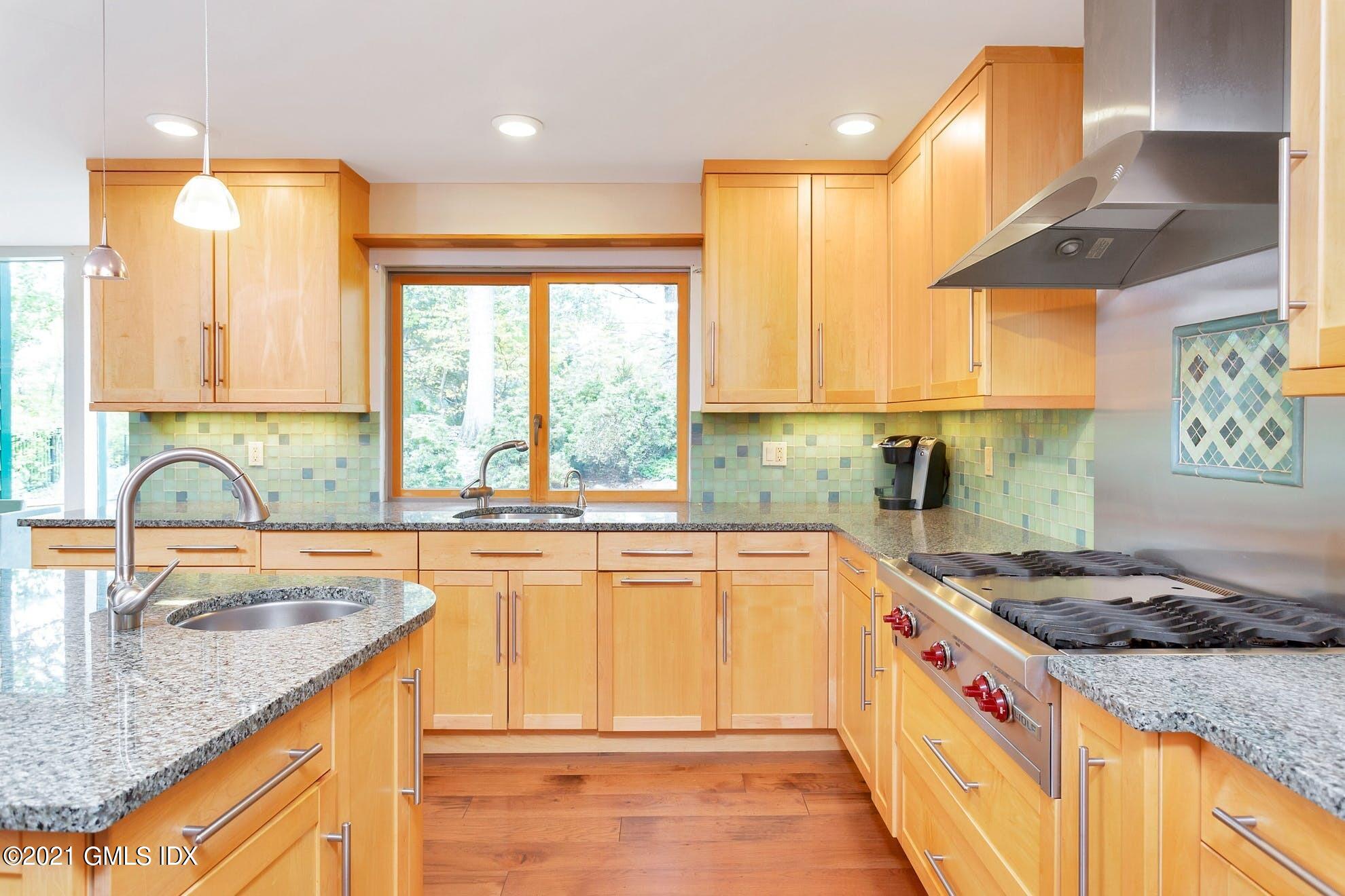 7 Chateau Ridge Road Greenwich, CT 06831 - Photo 8 of 36 a kitchen with kitchen island granite countertop a sink cabinets and window