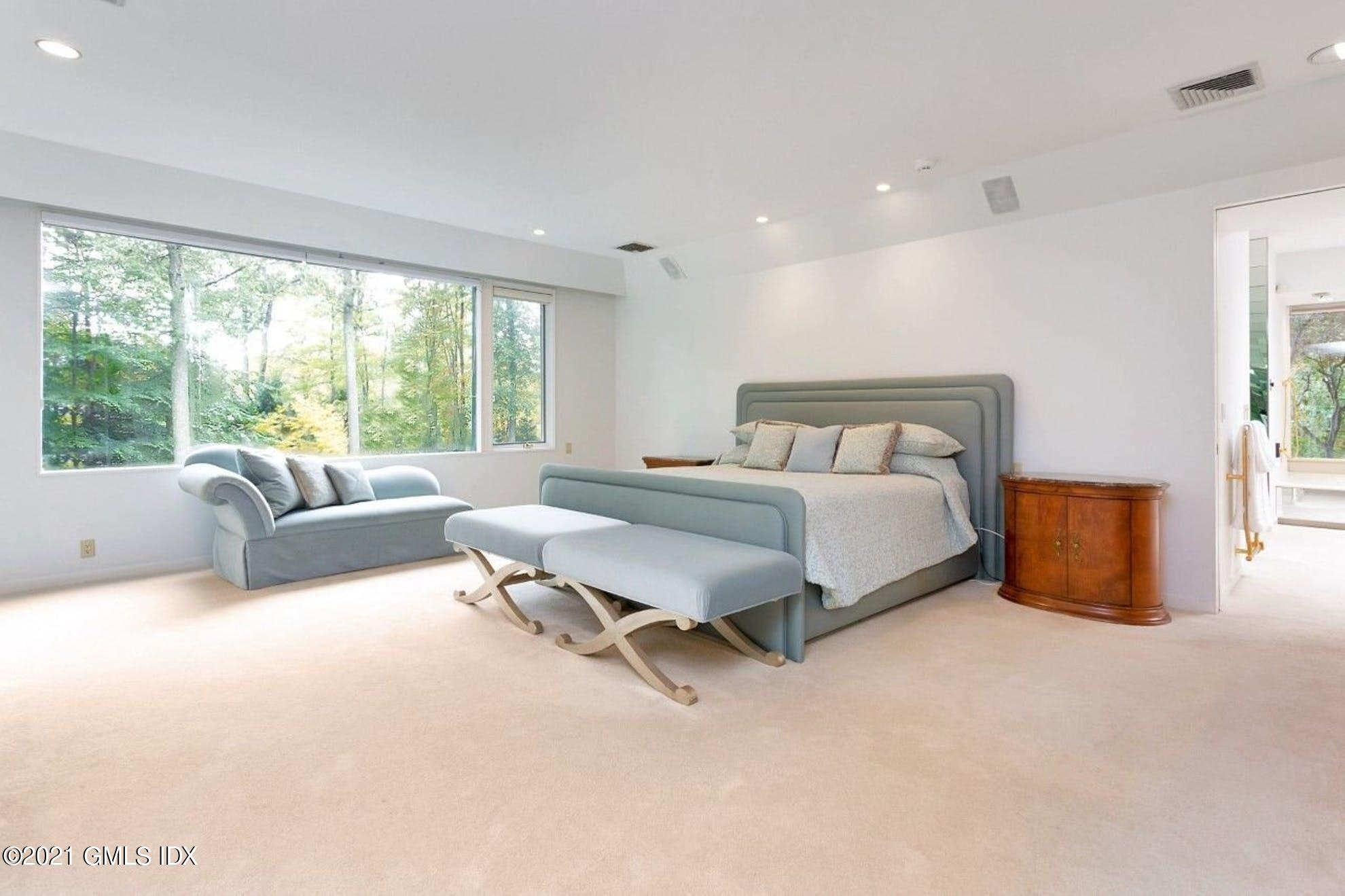 7 Chateau Ridge Road Greenwich, CT 06831 - Photo 10 of 36 a spacious bedroom with a bed and a couch