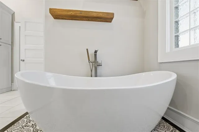 a white toilet sitting next to a bath tub