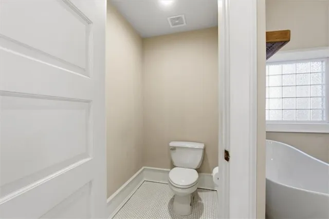 a kitchen with granite countertop a sink and dishwasher a refrigerator with wooden cabinets