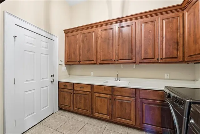 a utility room with sink dryer and washer