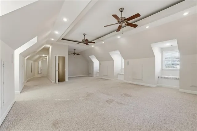 an empty room with a ceiling fan and window